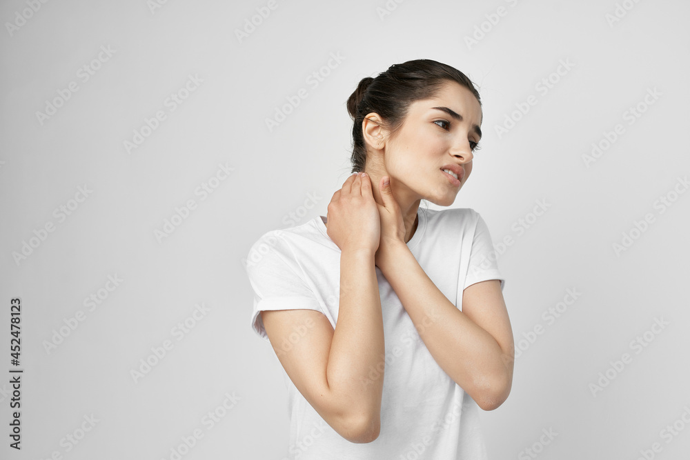 Woman in white t-shirt neck pain treatment health problem Woman in white t-shirt neck pain treatment health problem