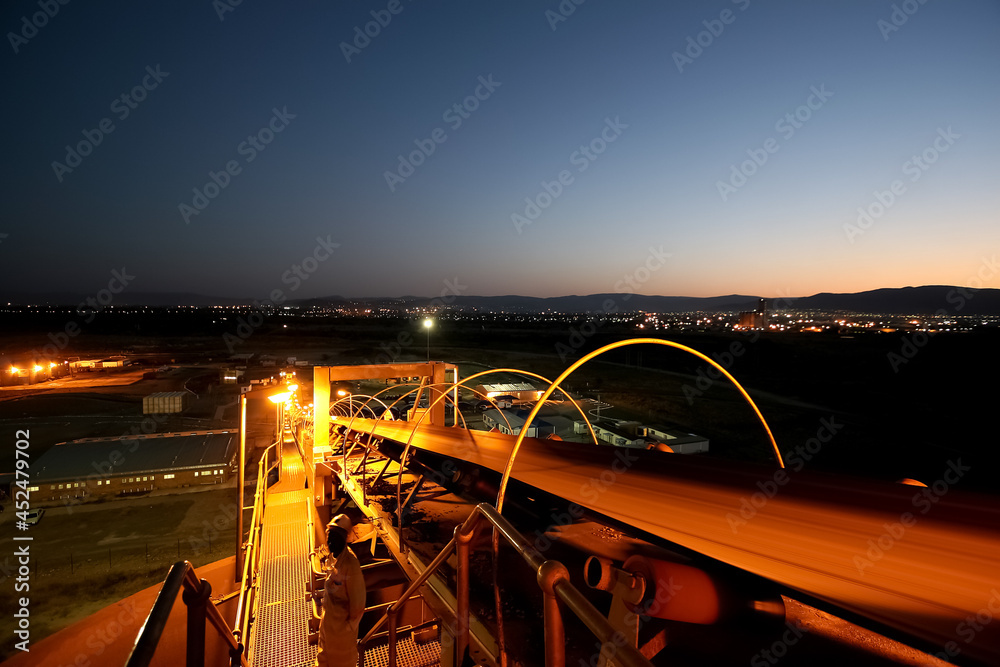 Fototapeta premium Conveyor belt for transporting ore rocks at precious metals mine in Johannesburg