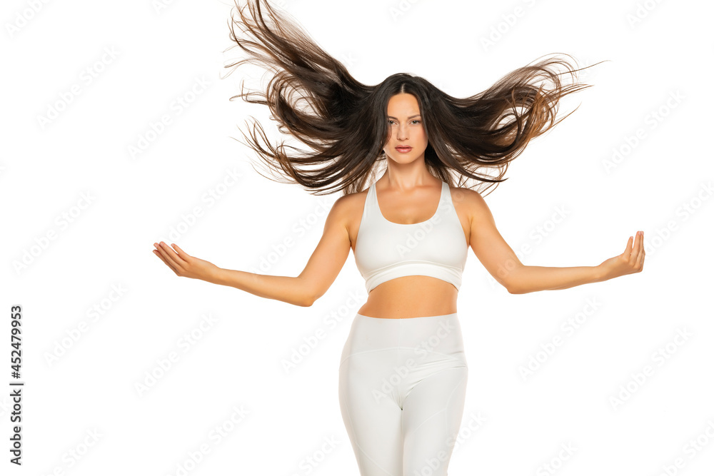 Fototapeta premium a young beautiful woman throws her long flying hair