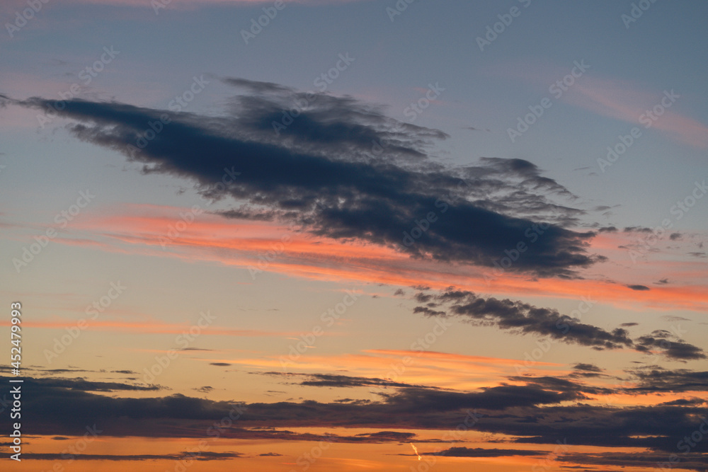 Pink, blue and gold clouds and sky at sunset on summer evening. Pink, blue and gold clouds and sky at sunset on summer evening.