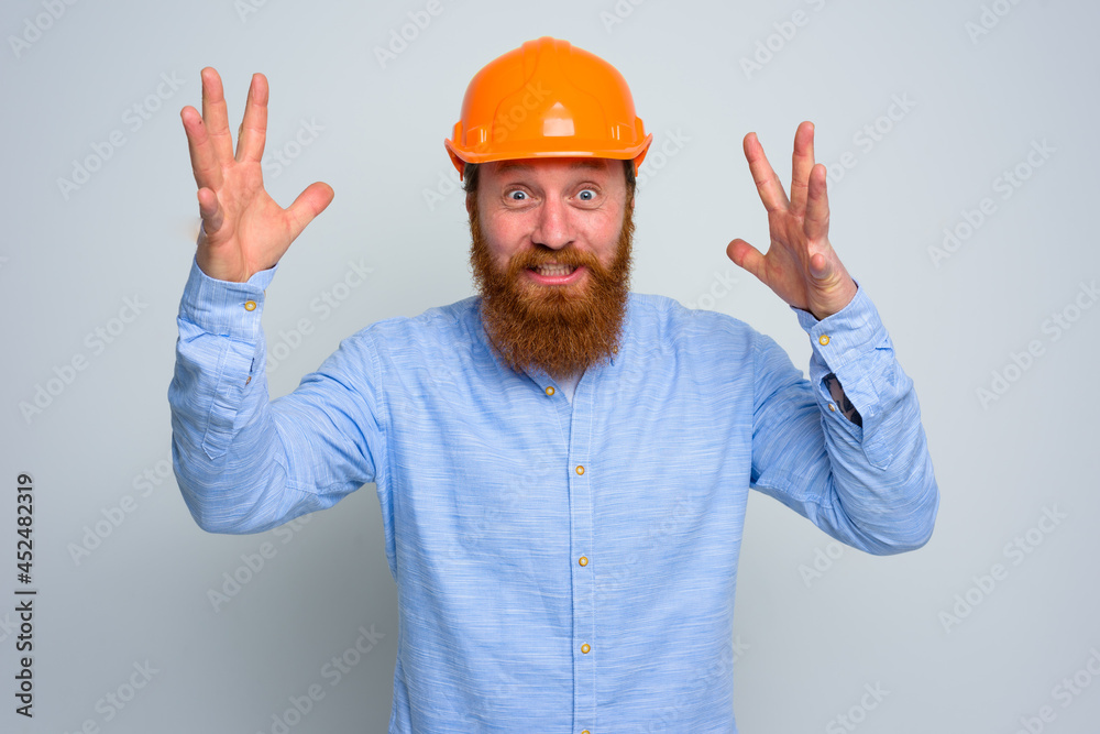 Isolated happy architect with beard and orange helmet