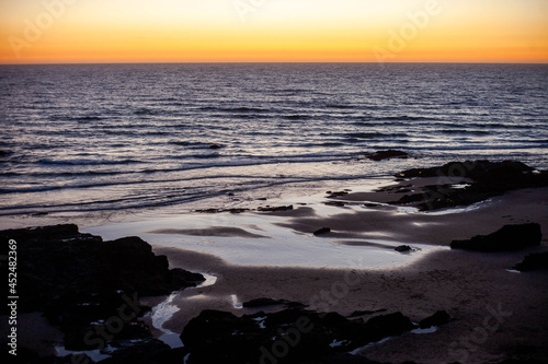 Praia do Malhão in Vila Nova de Mil Fontes Portugal, at sunset. photo