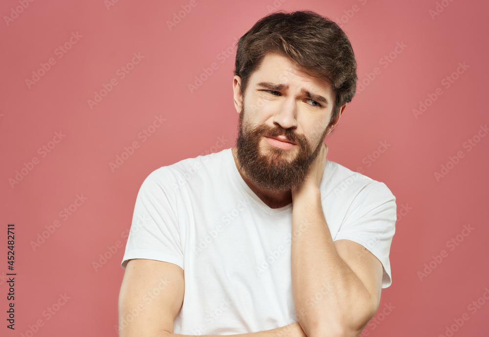 bearded man in a white t-shirt irritated facial expression close-up bearded man in a white t-shirt irritated facial expression close-up