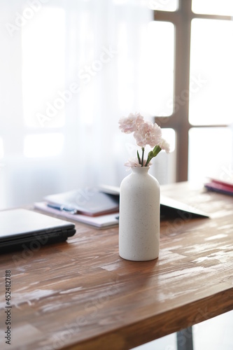 Flowers in vase on working desk