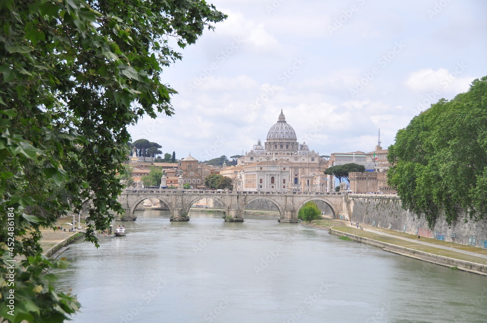 Amazing view of The Papal Basilica of Saint Peter behind Ponte Sant'Angelo on Tyber river, Rome, Italy