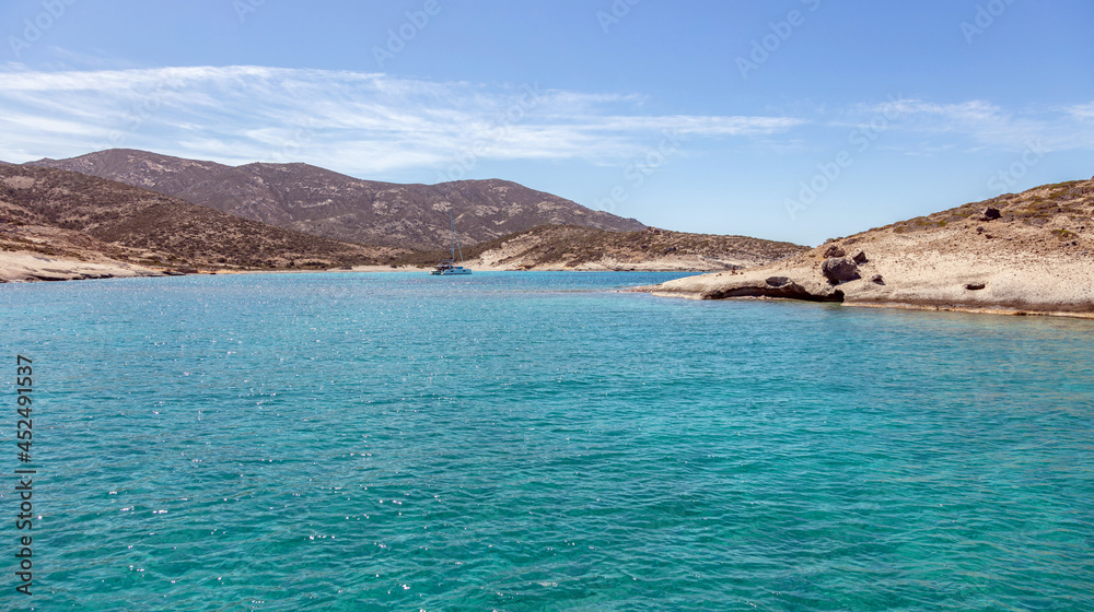 Polyaigos  island volcanic rocks formations  turquoise sea blue sky Cyclades Greece.