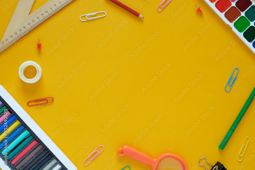 Flat lay. Yellow background. In the center there is an empty space. Stationery lies around. September 1, knowledge day, study, back to school, college. Flat lay. Yellow background. In the center there is an empty space. Stationery lies around. September 1, knowledge day, study, back to school, college.