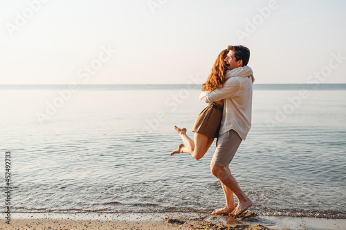Canvas Print Side view happy smiling young couple two friends family man woman in white cloth