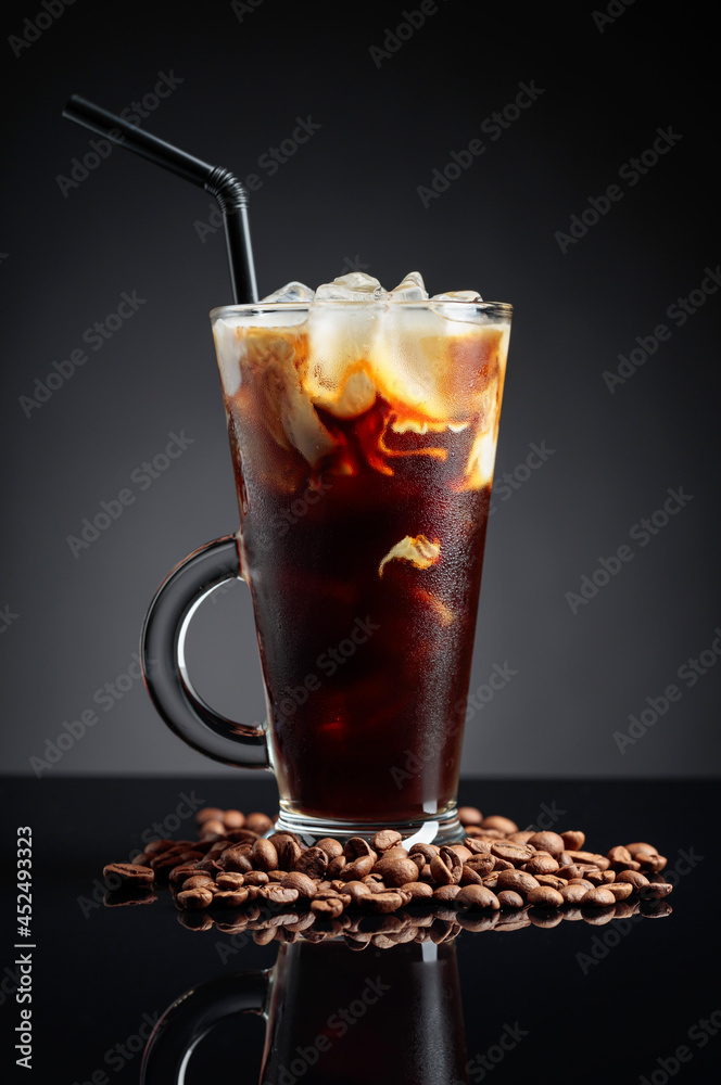 Ice coffee on a black reflective background. Ice coffee on a black reflective background.