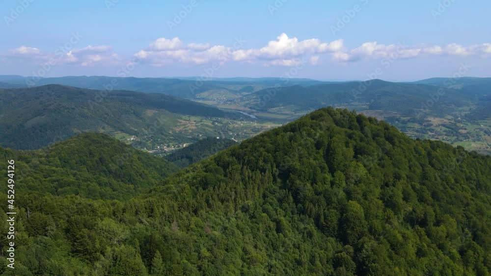 Сinematic aerial view of the endless mountains and forests of southern Slovenia. Drone flying through the forest