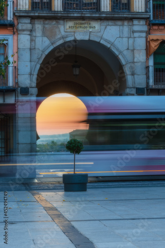 Street landscape in historical city. Stela cars passing through the street in front of the setting of the arch of light in Zocodover square in Toledo, World Heritage Site, Spain. Vertical view photo