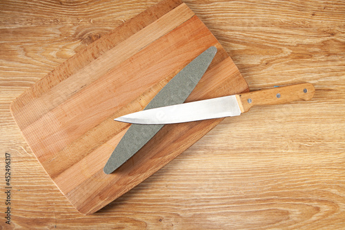 a stone sharpener and a knife on the table