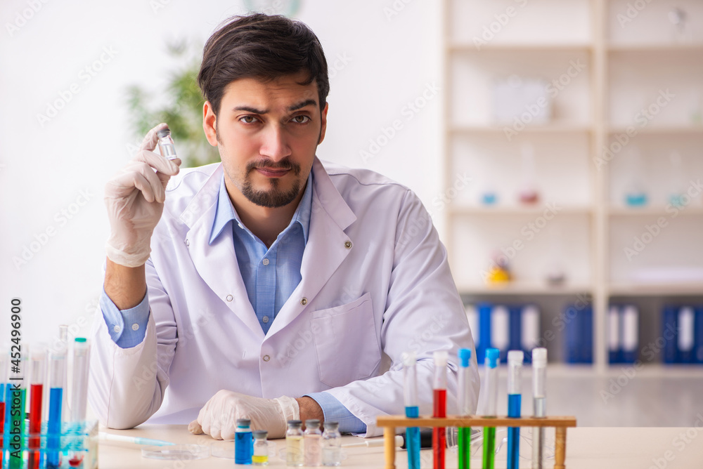 Young male chemist working at the lab Young male chemist working at the lab