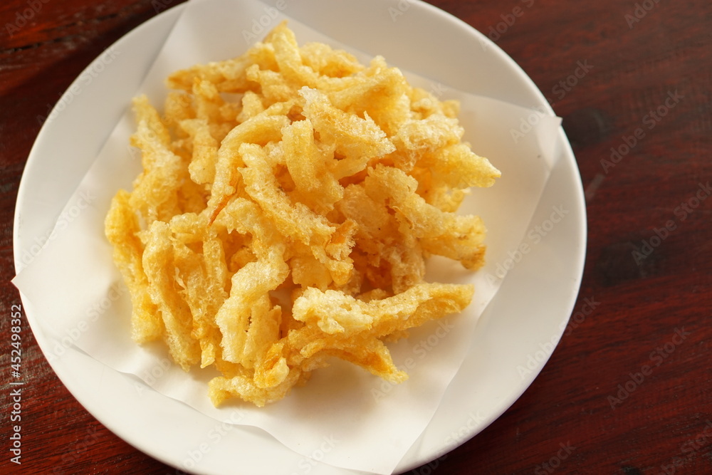 The top view of Delicious golden yellow crispy fish maw is Asian food and snack. The top view of Delicious golden yellow crispy fish maw is Asian food and snack.