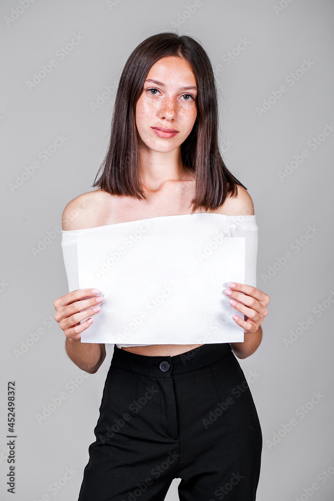 Young beautiful girl in studio isolated on gray background Young beautiful girl in studio isolated on gray background