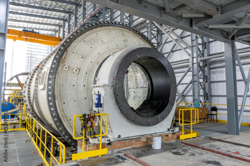 View of the large sag and ball mill in the mine factory. A ball mill is a type of grinder used to grind and blend materials for use in mineral dressing processes.