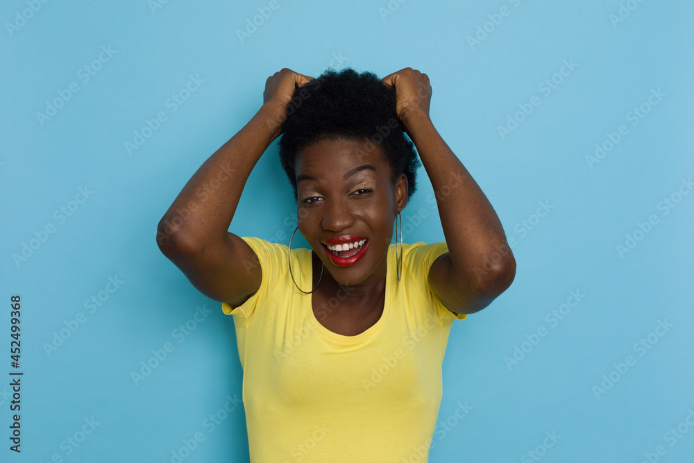 Laughing African Woman Pulls Her Short Black Hair Laughing African Woman Pulls Her Short Black Hair