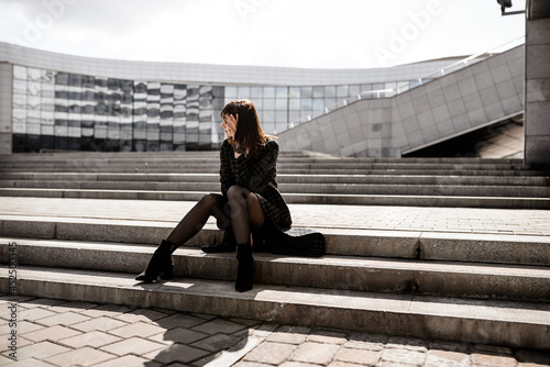 A girl on the background of a city business center