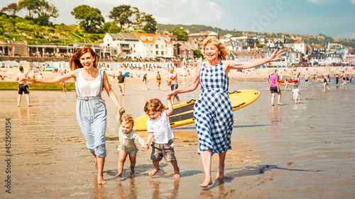 Multigenerational family is joyful and reunited during their summer holidyas in Lyme Regis, United Kingdom © Vivvi Smak