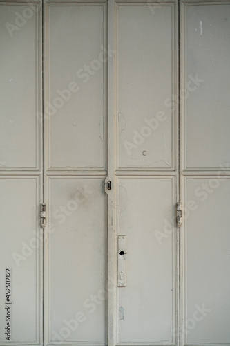 old white metal door of shophouse photo