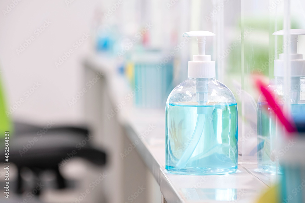 Blue alcohol gel bottle placed on the table to serve customers within a bank, measures to prevent the spread of respiratory viral disease