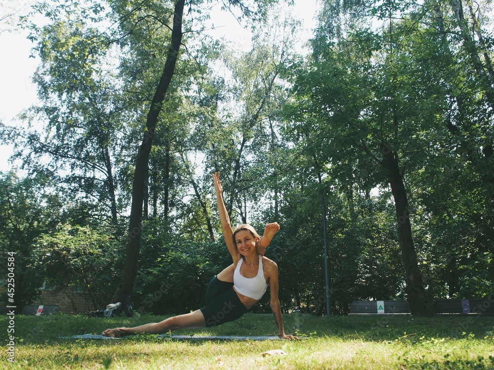 young woman doing yoga in the park outdoors young woman doing yoga in the park outdoors