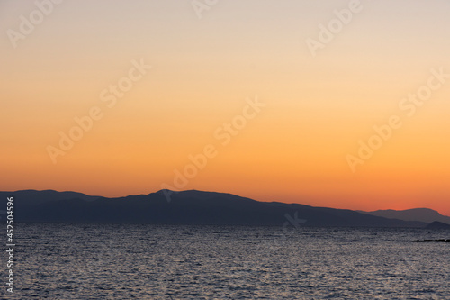 sunset on the sea over the port in Aegina in Greece