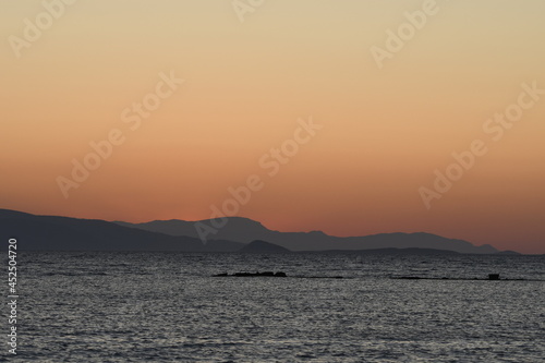 sunset on the sea over the port in Aegina in Greece © sergioboccardo