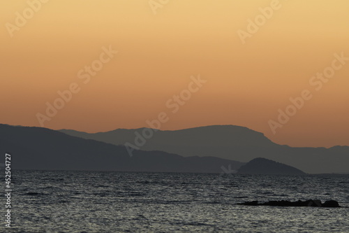 sunset on the sea over the port in Aegina in Greece