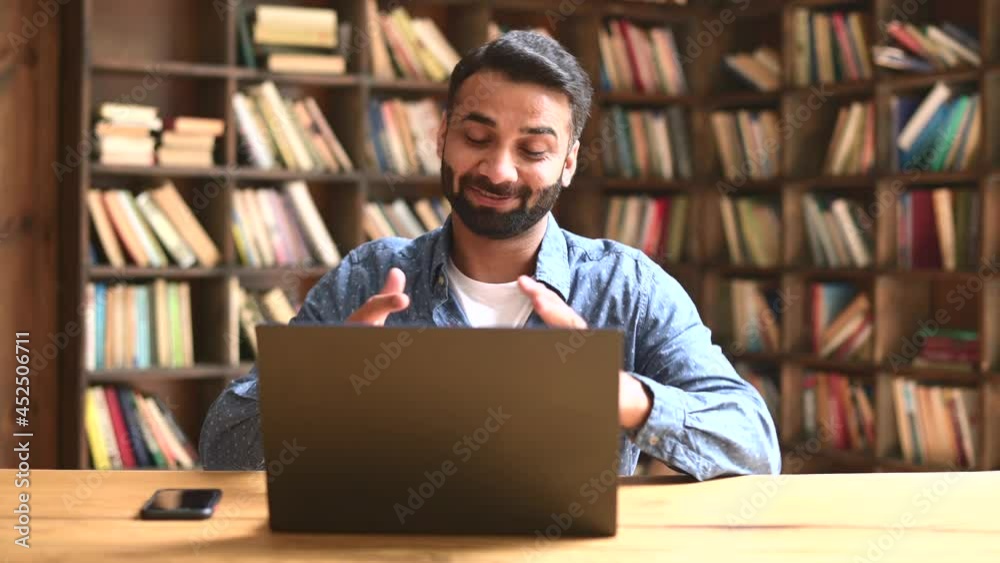 Confident smart indian freelancer guy working on laptop at home office, holding virtual meeting, multiracial eastern male employee using computer app for video call, involved virtual conference Confident smart indian freelancer guy working on laptop at home office, holding virtual meeting, multiracial eastern male employee using computer app for video call, involved virtual conference