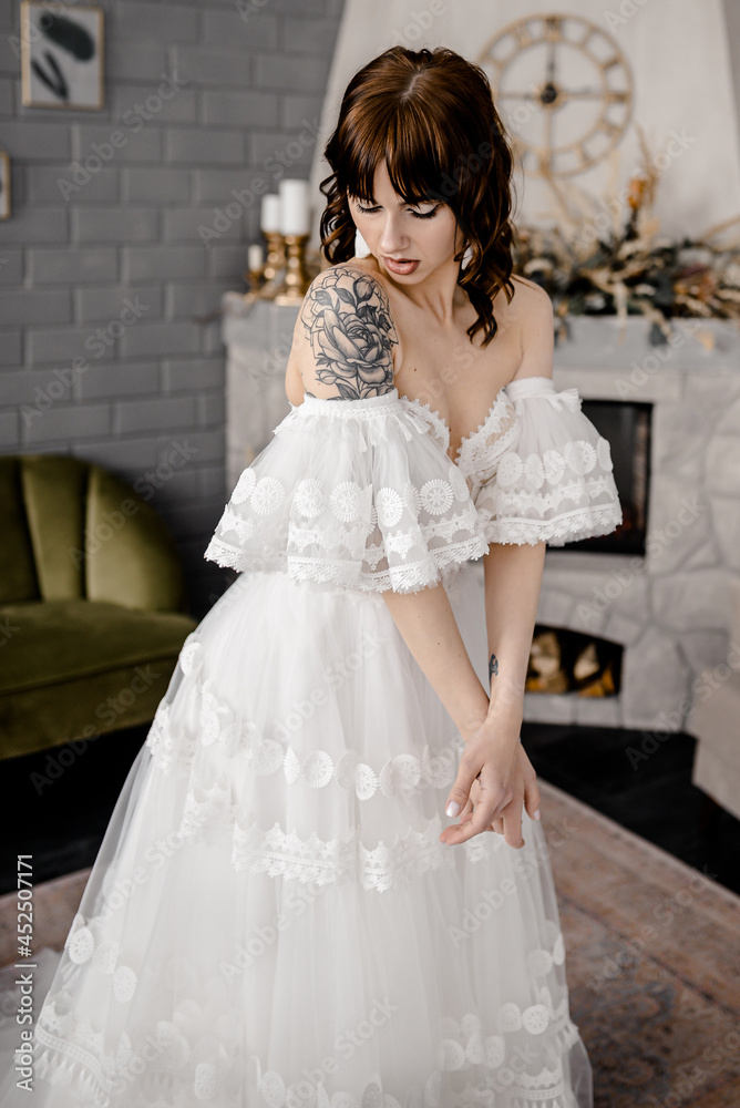 A girl in the image of a bride in a white soho style dress