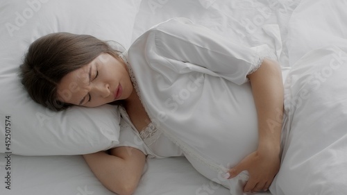 Labor Start. Worried Pregnant Woman Suffering Painful Contractions While Lying In Bed