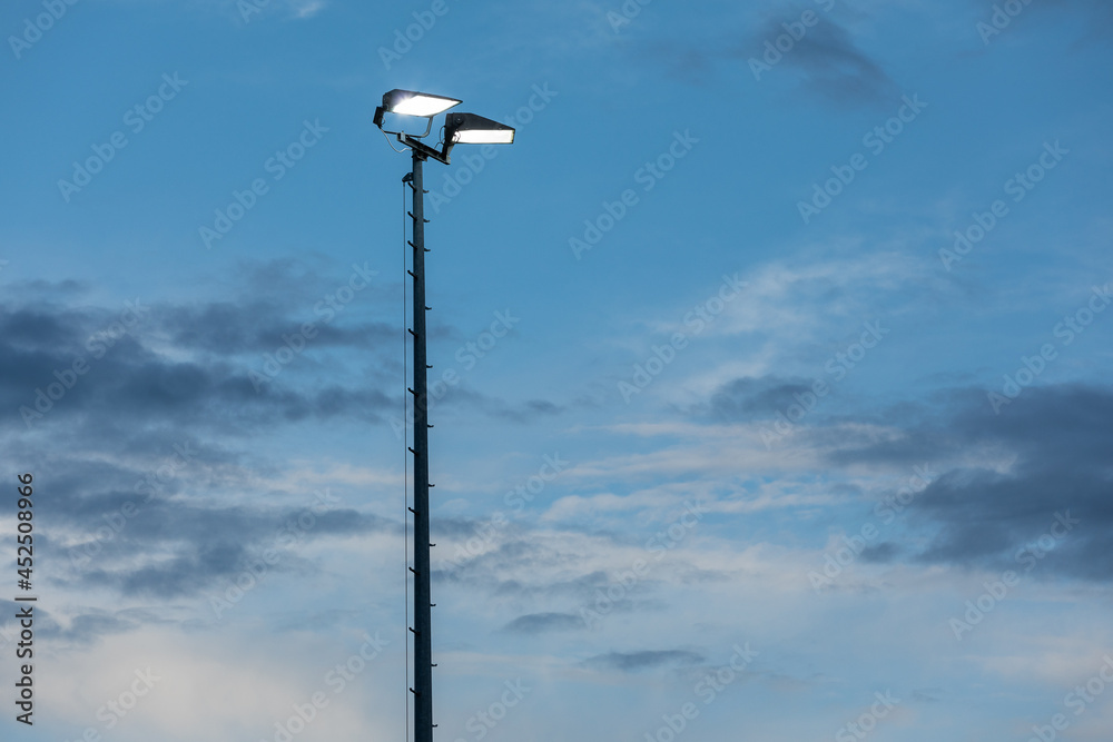 stadium lamp post against blue evening sky