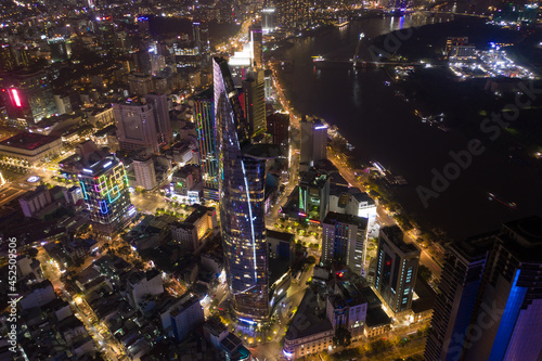 Aerial panoramic cityscape view of HoChiMinh City and Bitexco tower , Vietnam with blue sky at night .