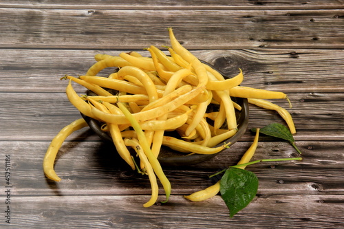 Fresh Yellow wax string beans on a dark wooden board background. Organic vegetables from farmer market, vegan food concept.Fresh Butter bean 