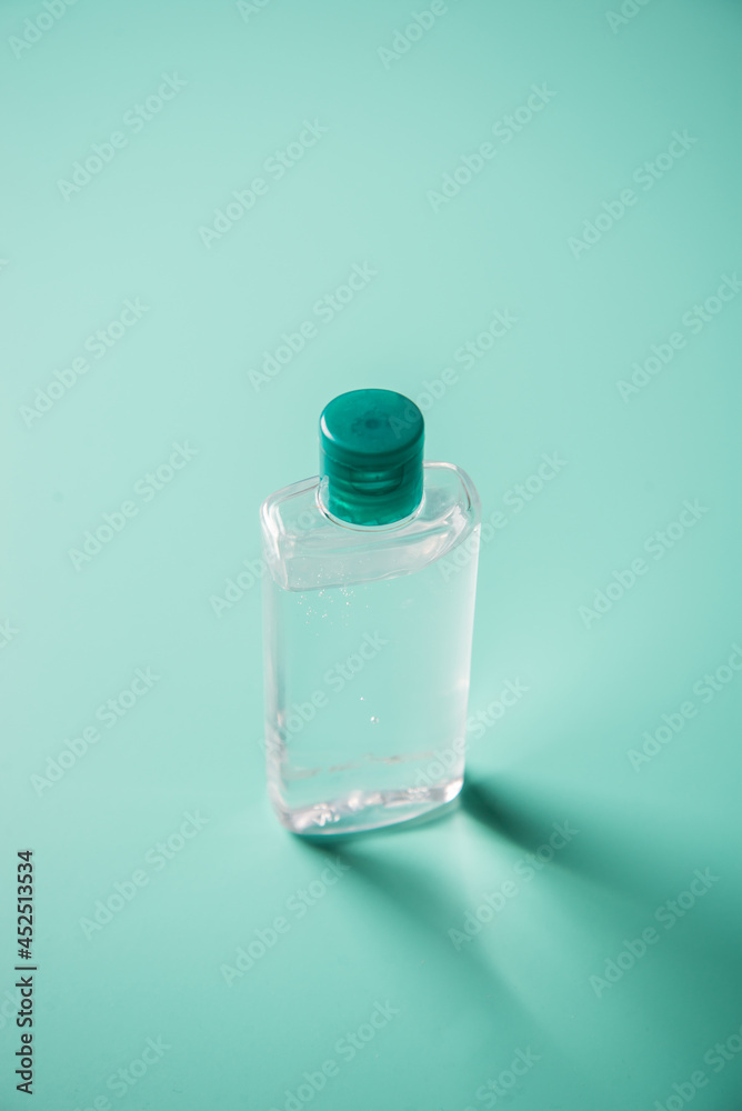 Coronavirus prevention hand sanitizer gel on table. Hand hygiene concept. Corona virus protection on blue background.