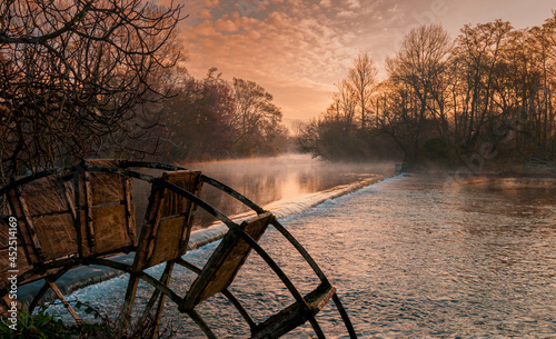 Partage des Eaux ,translation the parting of the water , L isle sur la sorgue , Vaucluse , France . at dawn with mist rising from the cold water .