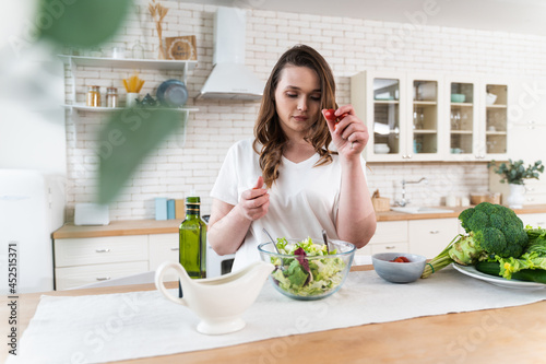 woman preparing a salad in the kitchen