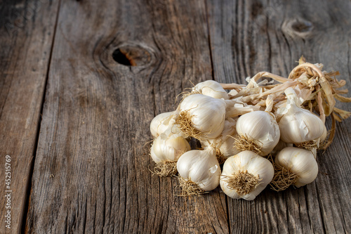 fresh ripe garlic on wood background. Copy space