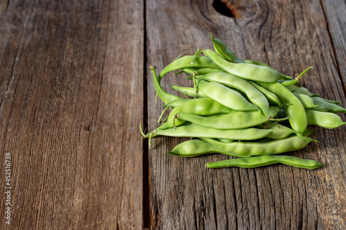 fresh ripe green beans on wood background. Copy space
