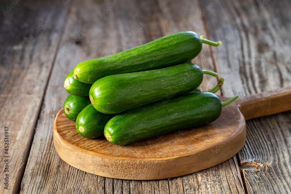 fresh ripe cucumbers on wood background. Close up fresh ripe cucumbers on wood background. Close up
