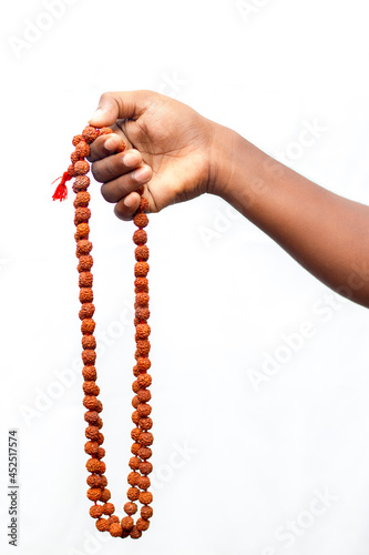 selective focus of a chanting hand with rudraksha beads. photo