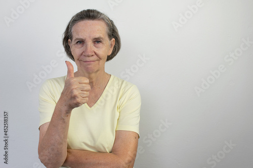 old female woman senior happy smile thumbs up retired aged expression friendly