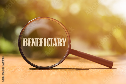 The word BENEFICIARY on magnifier in sunlight. photo