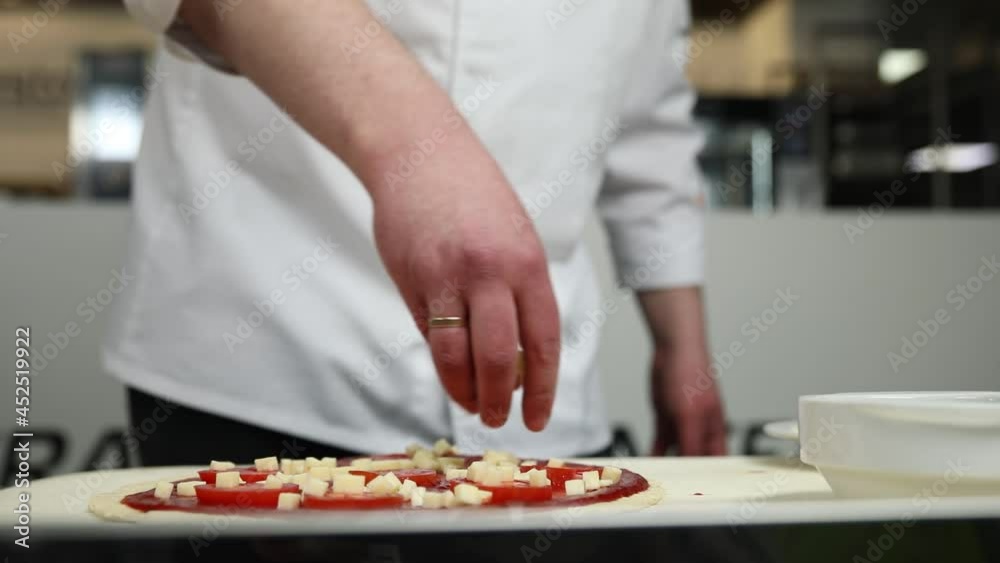The chef prepares pizza with sausage and vegetables
The chef prepares pizza with sausage and vegetables