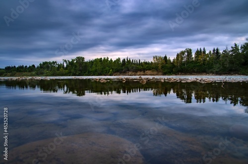 Fototapeta Naklejka Na Ścianę i Meble -  Moody Clouds Reflecting On The Bow River