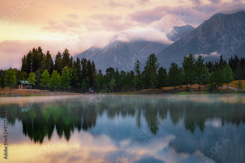 Cloudy Sunrise Over Quarry Lake And Mountains