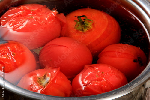Red ripe tomatoes in a pot of hot water. Boiled Tomatoes. tomatoes poached in boiling water © SHARKY PHOTOGRAPHY