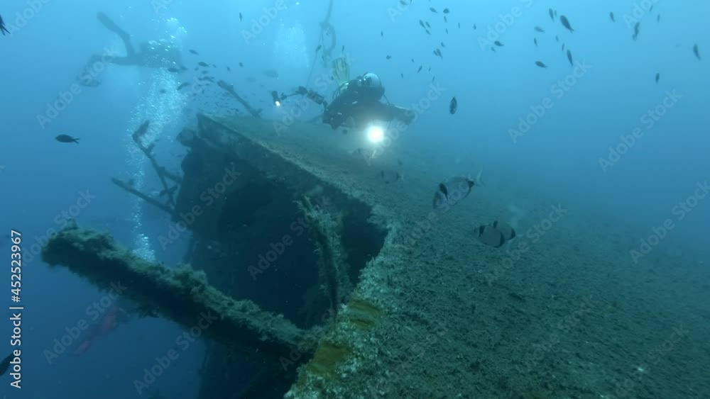 Scuba divers swims on the Shipwreck Swedish ferry MS Zenobia. Wreck diving. Mediterranean sea, Cyprus Scuba divers swims on the Shipwreck Swedish ferry MS Zenobia. Wreck diving. Mediterranean sea, Cyprus