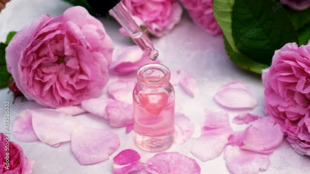 Tea rose essential oil in a small bottle. Selective focus. Tea rose essential oil in a small bottle. Selective focus.